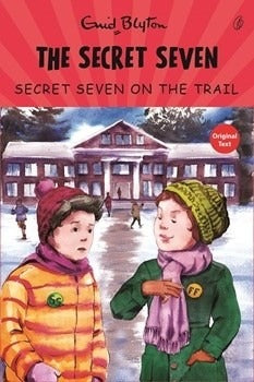Children's mystery book cover with illustrated kids, house, and title 'The Secret Seven'.