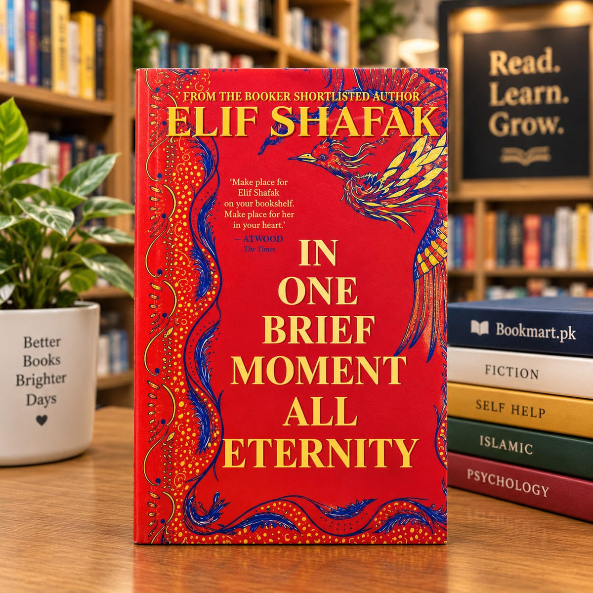 Red hardcover book with ornate cover art and large title text 'In One Brief Moment'